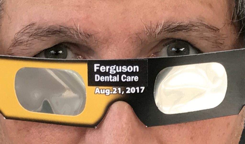 Man wearing eclipse glasses